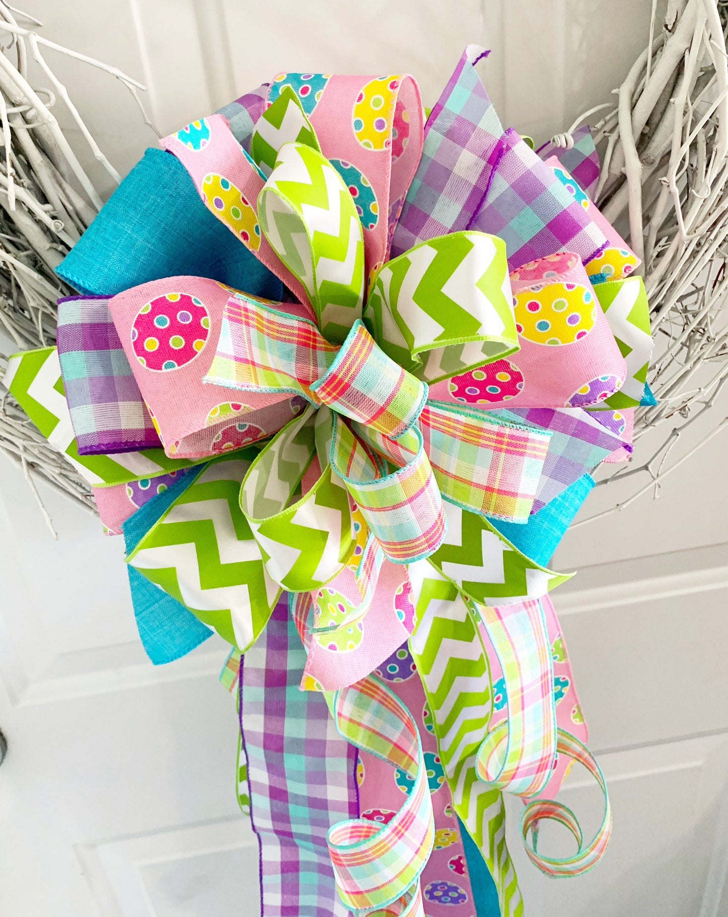 Easter Bow in Light Green and Pink with Multipattern Ribbon Featuring Eggs. Perfect for mailbox, Door, and Wreath.