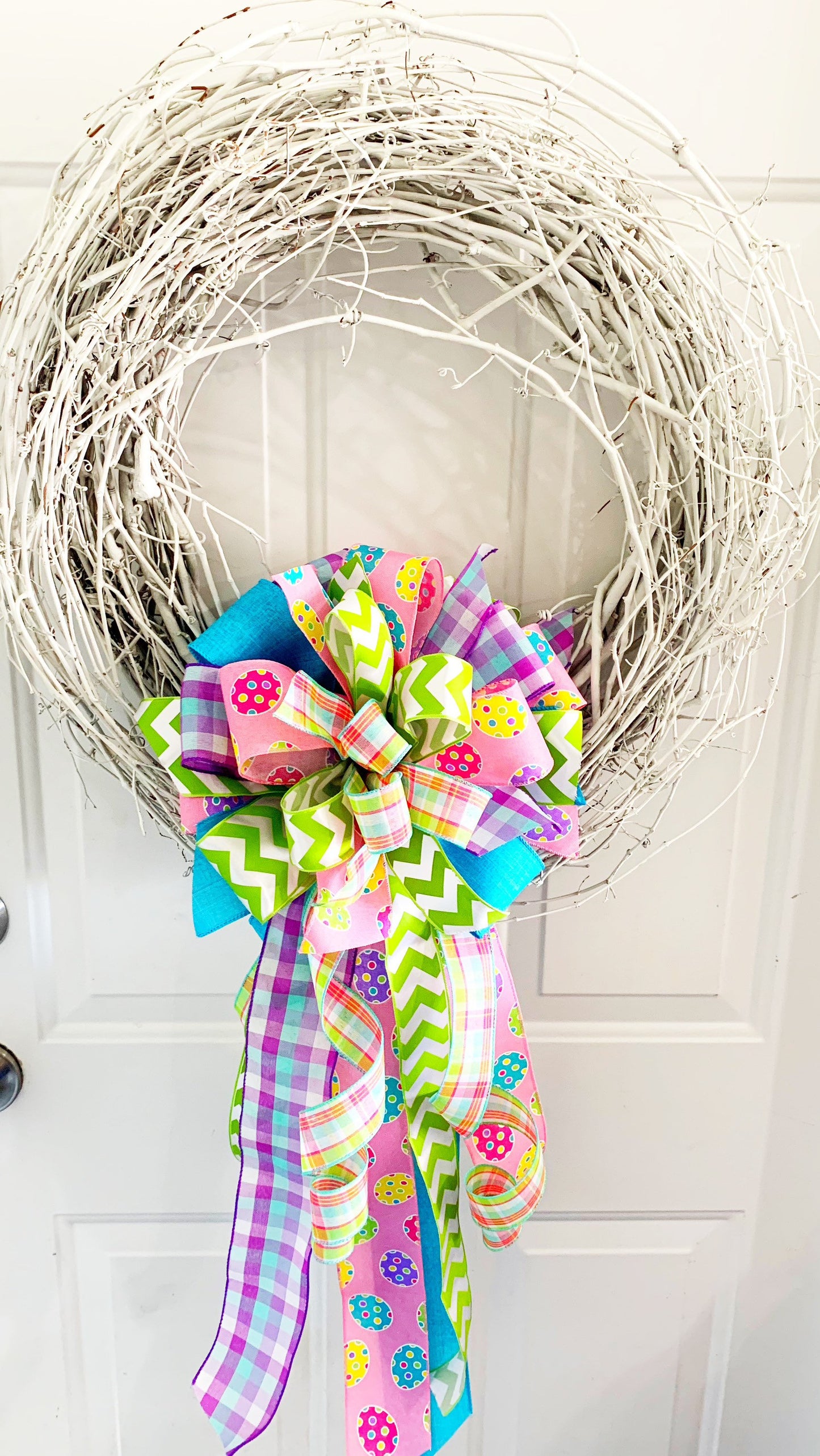 Easter Bow in Light Green and Pink with Multipattern Ribbon Featuring Eggs. Perfect for mailbox, Door, and Wreath.