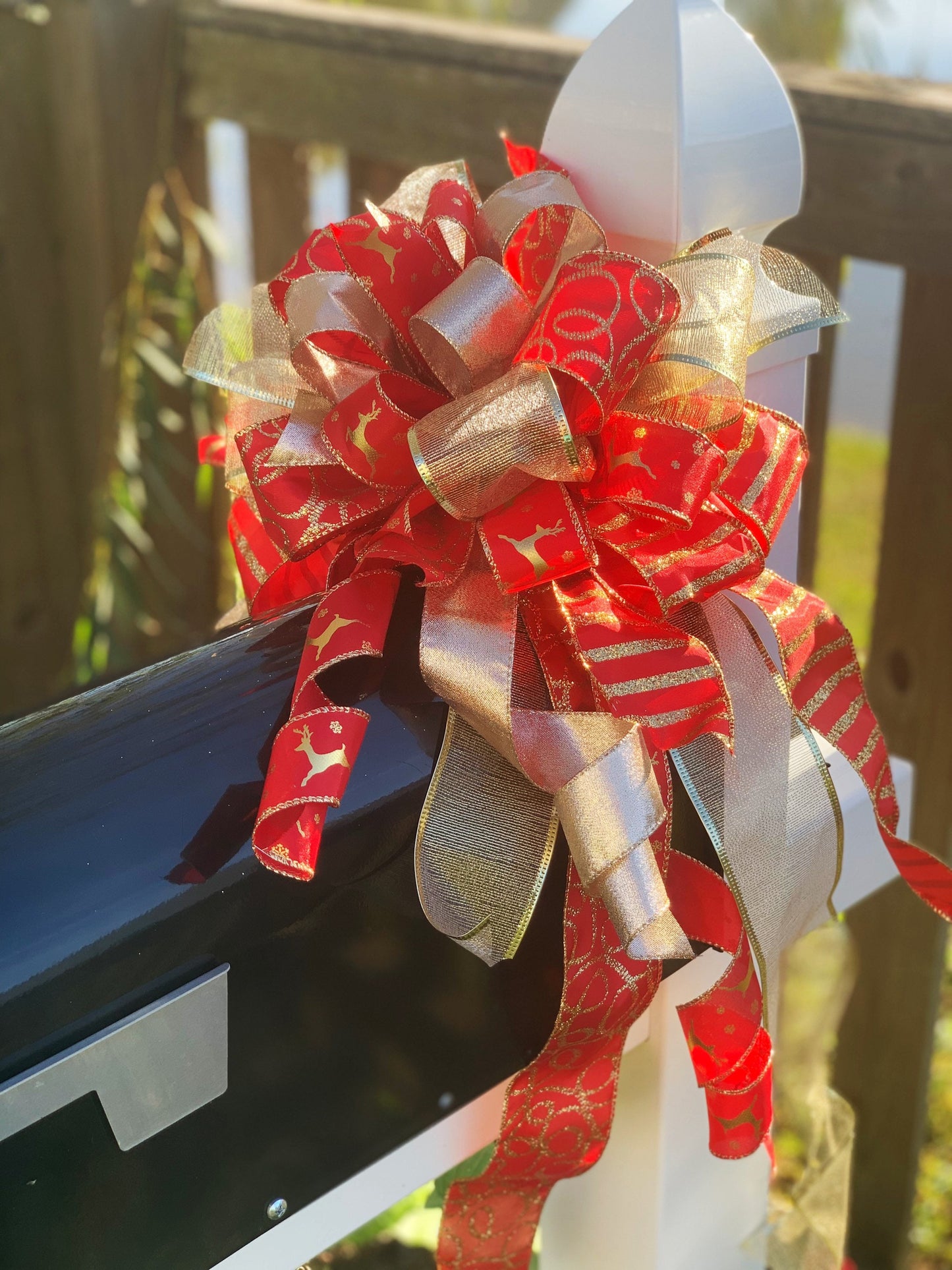 Christmas Bow in Red and Gold Featuring Gold Reindeer Ribbon. Perfect for Mailbox, Door, or Wreath.