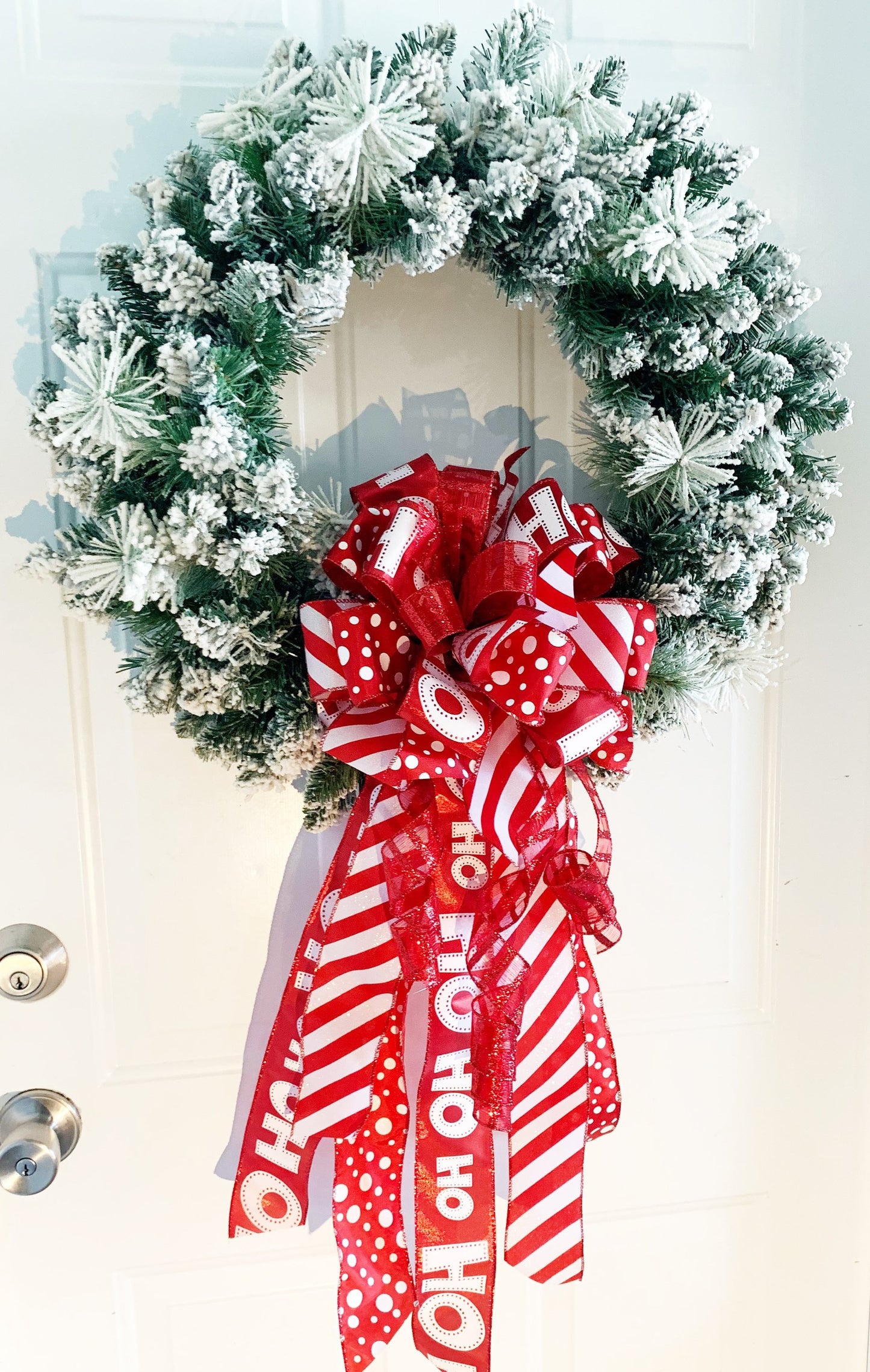 Christmas Bow in Red and White Featuring Santa Claus' Iconic HO HO HO Ribbon. Perfect for Mailbox, Door, and Wreath.