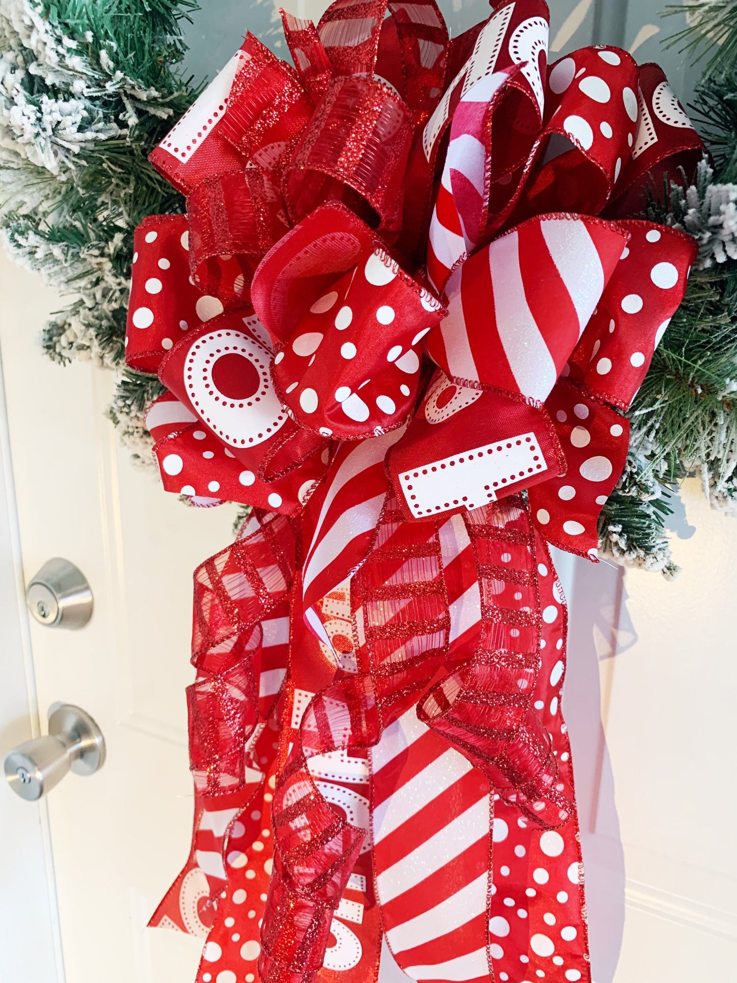 Christmas Bow in Red and White Featuring Santa Claus' Iconic HO HO HO Ribbon. Perfect for Mailbox, Door, and Wreath.