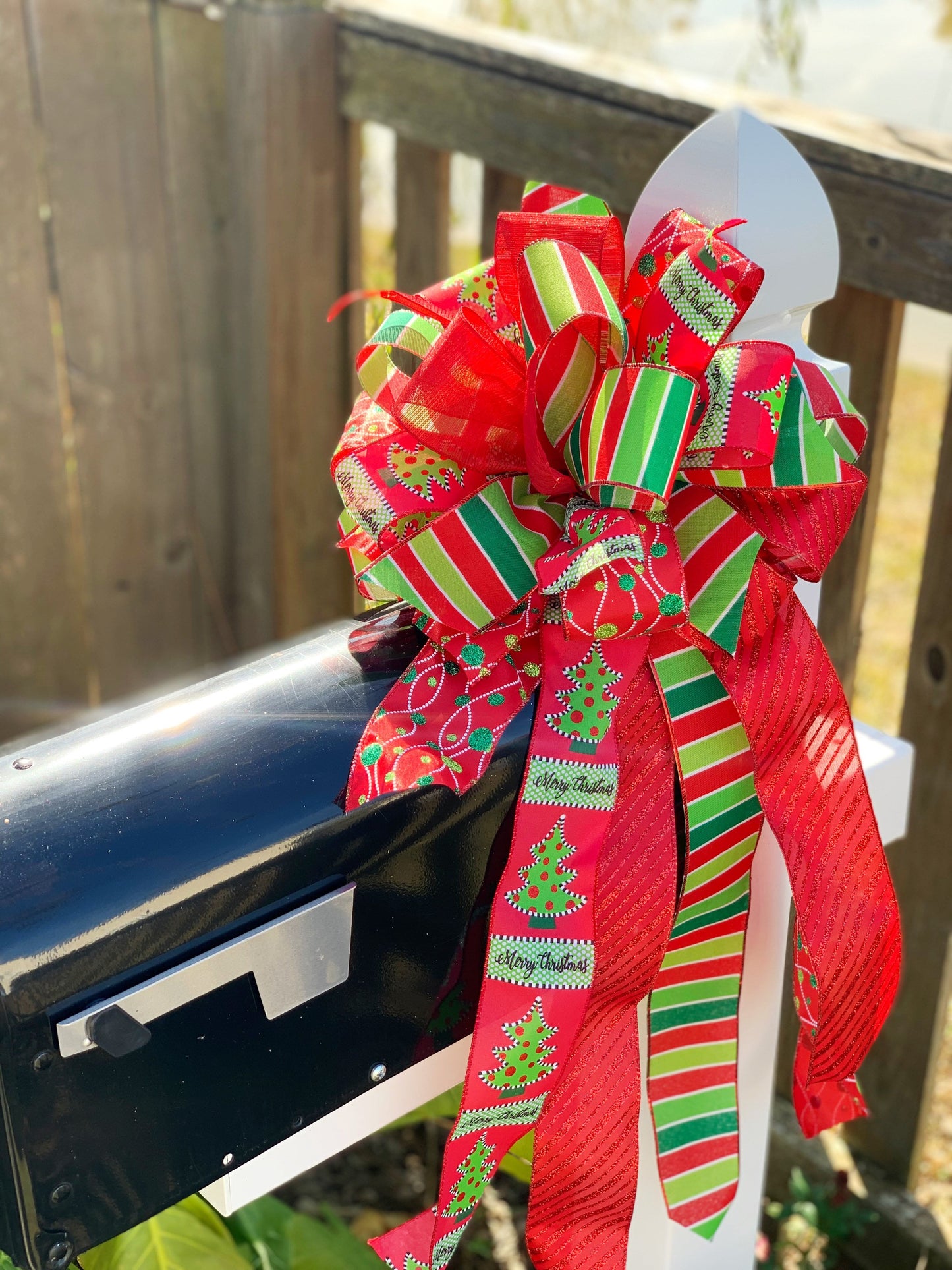 Christmas Bow in Green and Red Featuring Ribbon with Christmas Tree and "Merry Christmas" Ribbon. Perfect for Mailbox, Door, and Wreath.