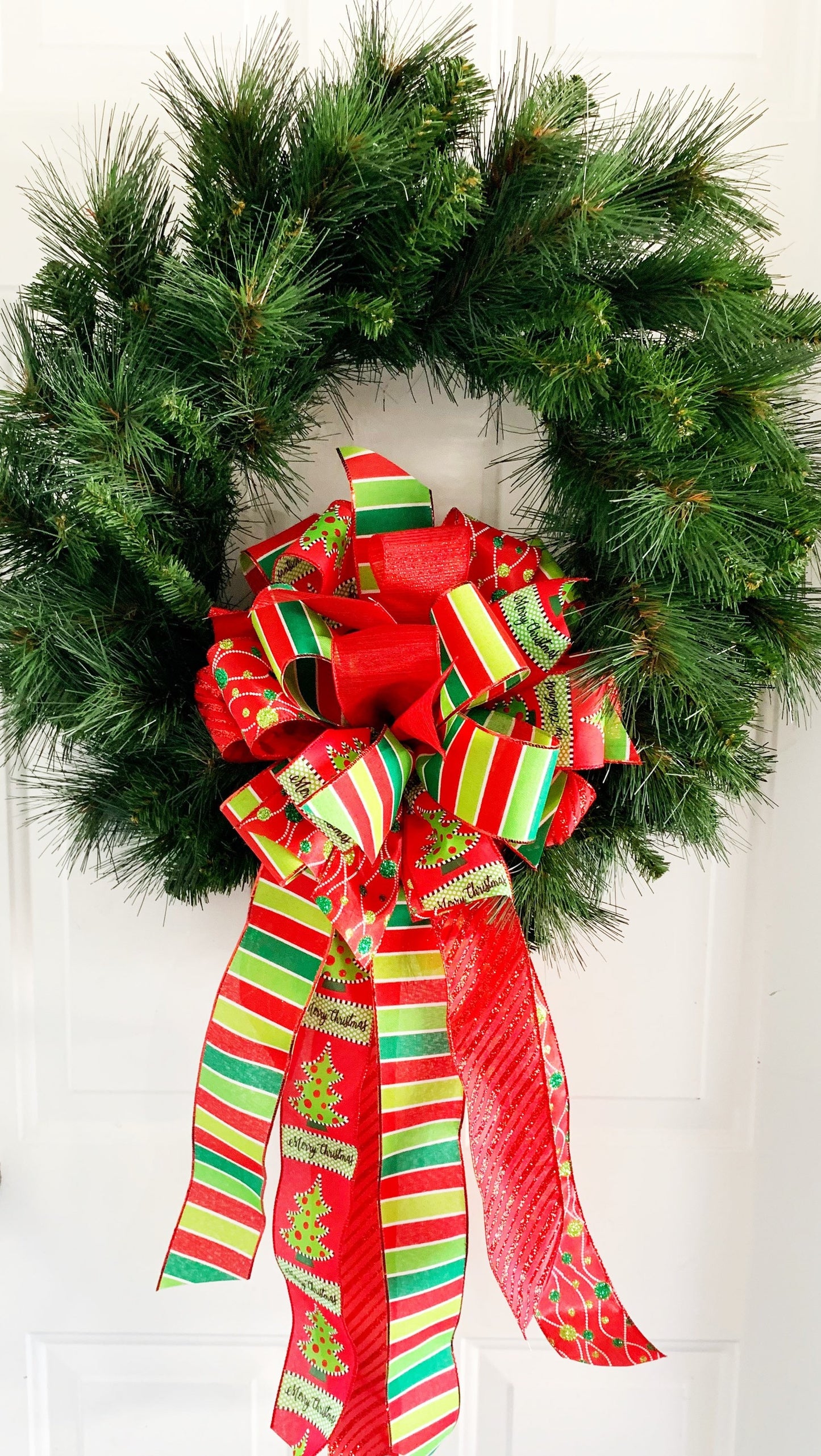 Christmas Bow in Green and Red Featuring Ribbon with Christmas Tree and "Merry Christmas" Ribbon. Perfect for Mailbox, Door, and Wreath.